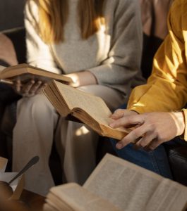 high-angle-people-reading-together